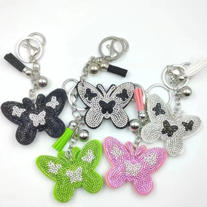 Detailed view of colorful butterfly keychains with rhinestones and leather tassels