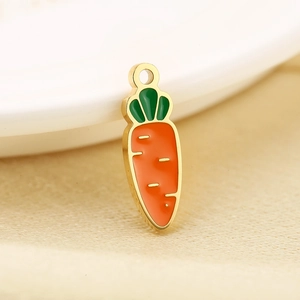 Macro shot of carrot pendant with orange enamel and gold-plated finish for DIY jewelry
