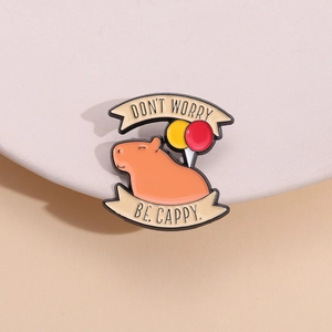 Cartoon capybara enamel pin with balloons and 'Don't Worry Be Cappy' text banner