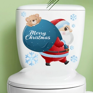 Detailed Santa Claus and blue snowflake decals on a clean white toilet tank surface