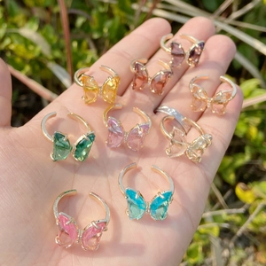 Collection of colorful butterfly crystal rings in gold finish with adjustable open bands