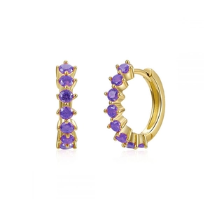 Detailed view of golden huggie earrings featuring micro-paved purple cubic zirconia stones
