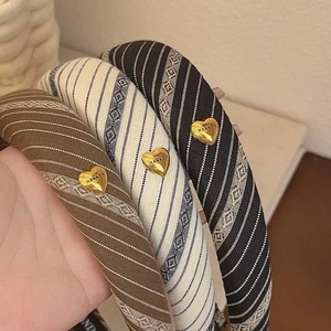 Striped fabric padded headbands with gold heart detail in brown, blue and black