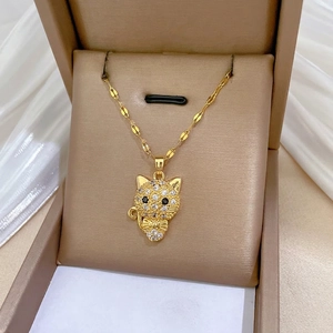 Luxe gold-plated bow cat necklace with sparkling crystal inlay on a satin jewelry box