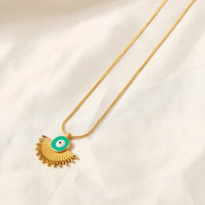 Vintage evil eye fan-shaped pendant necklace in gold-plated steel on soft fabric