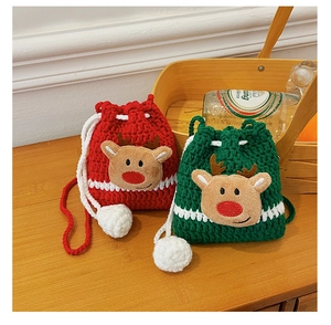 Detail of Christmas reindeer crochet drawstring bags in red and green knitted fabric