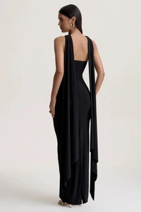 Detailed back view of a slim-fit black halter dress featuring elegant long trailing ribbons
