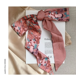 Detail of a vintage pink silk scarf with embroidery and traditional oil painting pattern
