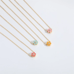 Detail view of colorful floral enamel pendants with gold-plated chains and zircon center