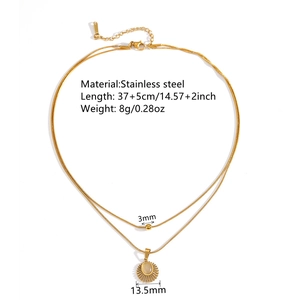 Gold double-layered stainless steel necklace with sun pendant and cat eye stone detail