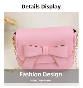 Detail shot of pink mini crossbody bag with a large bow and gold chain strap