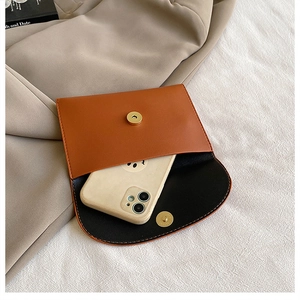 Detail view of woven leather bag interior with magnetic clasp and smartphone storage