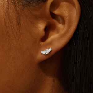 Close-up of S925 sterling silver heart crown stud earring with clear crystals on ear