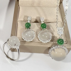 Detail of silver jewelry set with white ice chalcedony and green jadeite gemstones