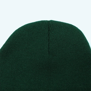 Macro shot of the dark green beanie top showing premium knit texture and stitching detail