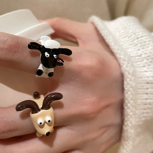 Macro detail of Shaun the Sheep and Bitzer character rings with 3D enamel finish