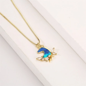 Macro detail of unicorn pendant with blue-green gradient finish and white zircon stones