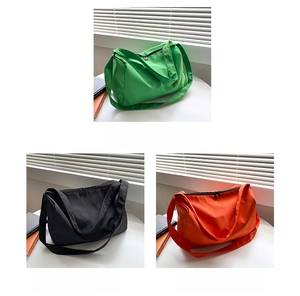 Detailed view of lightweight oxford fabric tote bags in green, black, and orange colors