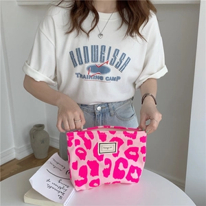 Detailed close-up of pink leopard print canvas tote bag with pleasant time logo label