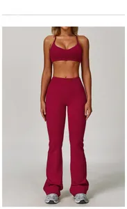 Dettaglio del set yoga rosso lampone con reggiseno a spalline sottili e leggings svasati