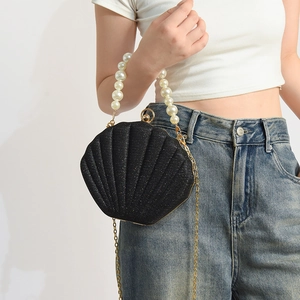 Elegant black shell-shaped handbag with glitter finish and pearl handle chain