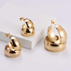 Polished 18k gold plated stainless steel chunky C-shaped hoop earrings on white blocks