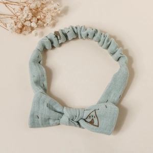 Detail of baby cotton headband showing Morandi blue fabric texture and teepee print