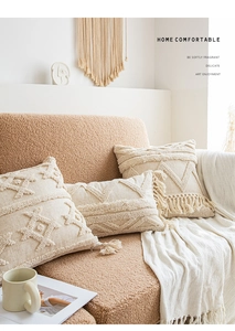 Detail of bohemian tufted pillow covers with tassels in beige cotton linen fabric