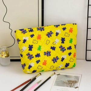 Detailed view of quilted cotton cosmetic bag with colorful cartoon bear pattern