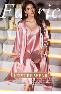 Detail of pink satin 3-piece loungewear with elegant lace trim and smooth fabric texture