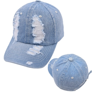 Detail view of light blue denim baseball cap featuring distressed torn fabric and texture
