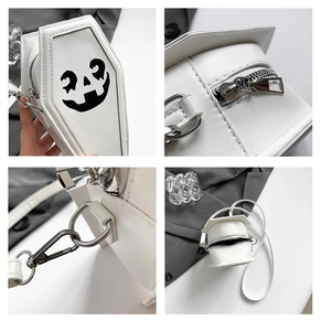 Detail view of white coffin cross body bag with pumpkin print and silver metal zippers
