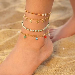 Bohemian 4-piece colorful beaded anklet set with pearls and evil eye charm on the beach