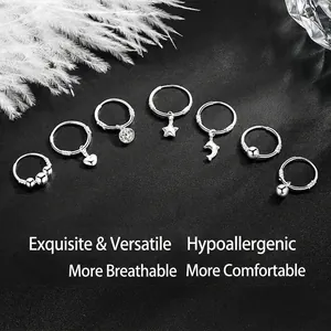 Set of 7 S999 silver hoop earrings with diverse charms like stars and hearts on leather