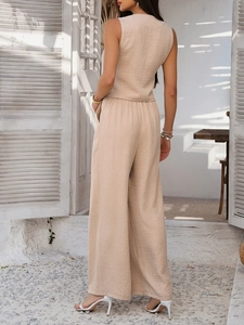 Back view of beige textured sleeveless top and wide-leg trousers set in sunny outdoor