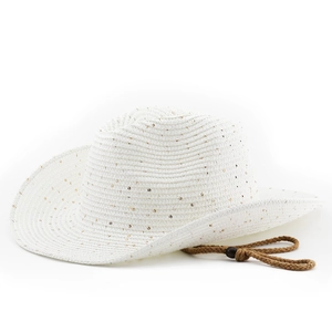 Detail of white straw cowboy hat featuring gold sequins and adjustable brown wind cord