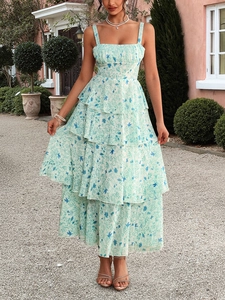 Detail of light green floral chiffon maxi dress with layered ruffles and bird print