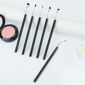 Macro detail of 6-piece professional eye makeup brush set with black handles and silver ferrules