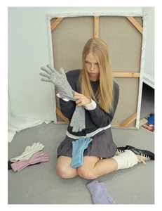 Detail showing soft wool blend knit gloves with touchscreen feature in grey color