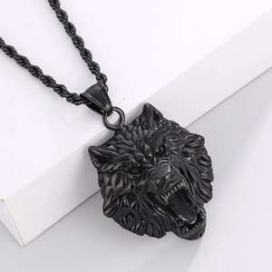 Detailed macro view of a black stainless steel wolf head pendant with thick rope chain