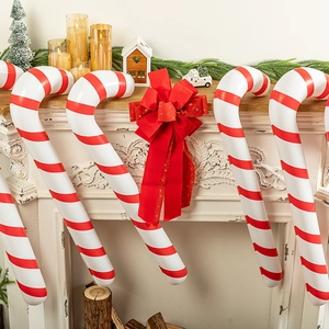 Inflatable candy canes with red and white stripes for Christmas fireplace decoration