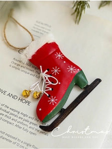 Detail von rotem Schlittschuh-Weihnachtsanhänger aus Eisen mit Schneeflocken und Glocken