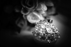 Artistic black and white detail of a 12mm wide polished metal ring on a floral holder