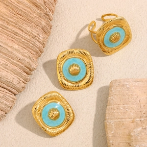Detail of vintage 18K gold plated jewelry set with turquoise enamel shell patterns