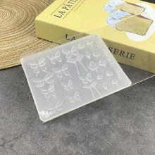 Detailed view of translucent silicone nail art mold featuring intricate butterfly patterns
