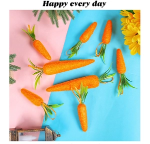 Detail of plush Easter carrot decorations with green leaves on a vibrant split background