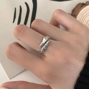 Detailed view of punk dragon claw ring on finger with vintage silver finish and texture