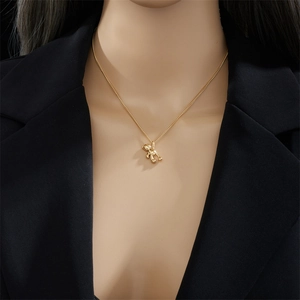 Minimalist gold 3D bear pendant necklace made of titanium steel on female model