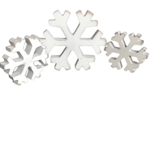 Set of three vintage white wooden snowflake ornaments for Christmas tabletop decoration