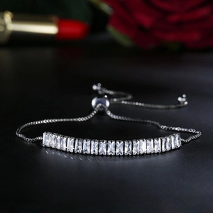 Detail of adjustable zircon bracelet with sliding buckle on elegant dark background